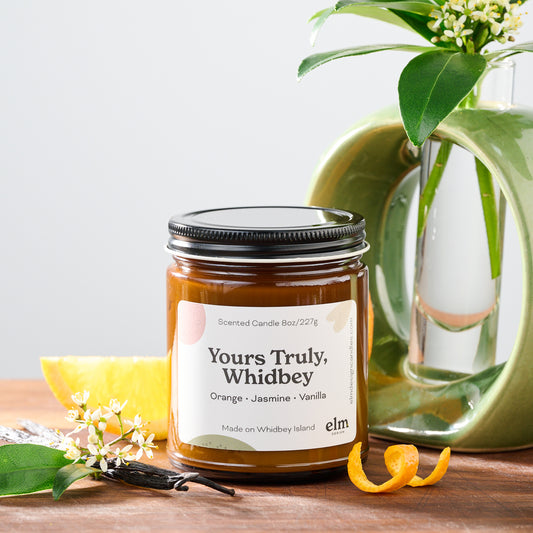 Yours Truly, Whidbey scented soy candle in an 8oz amber glass jar.