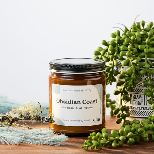 Obsidian Coast scented soy candle in an 8oz amber glass jar.