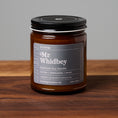 Load image into Gallery viewer, Mr. Whidbey scented soy candle in amber glass jar on wooden surface.