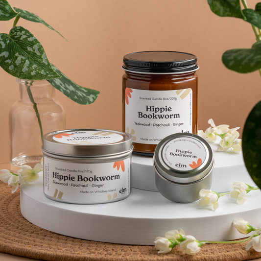 Hippie Bookworm scented soy candles in colorfully labeled 8, 6 and 2 oz containers.