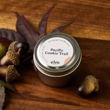 Load image into Gallery viewer, Elm Designs Pacific Cookie Trail scented candle in a 2oz metal tin.
