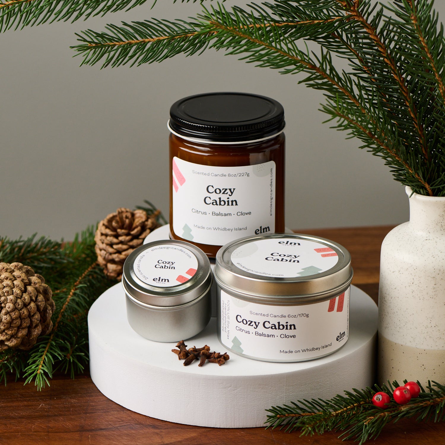 Elm Design's Cozy Cabin scented candle in 8oz, 6oz, & 2oz sizes.