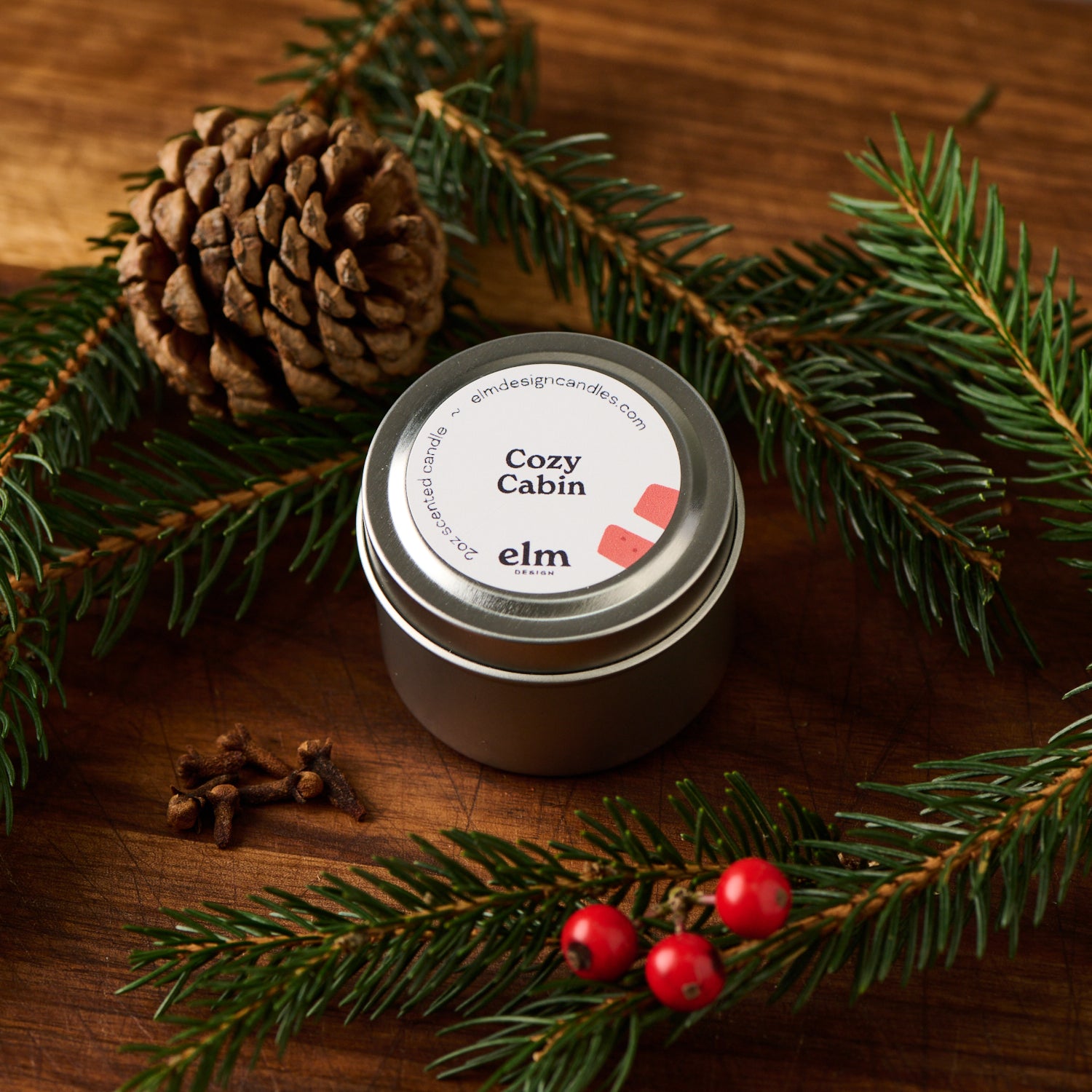 Elm Design's Cozy Cabin scented candle in an 2oz metal tin.