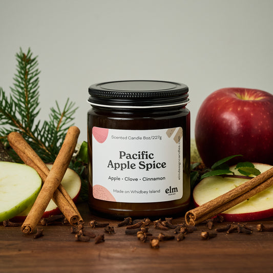 Elm Design's scented candle "Pacific Apple Spice" in an 8oz glass jar.