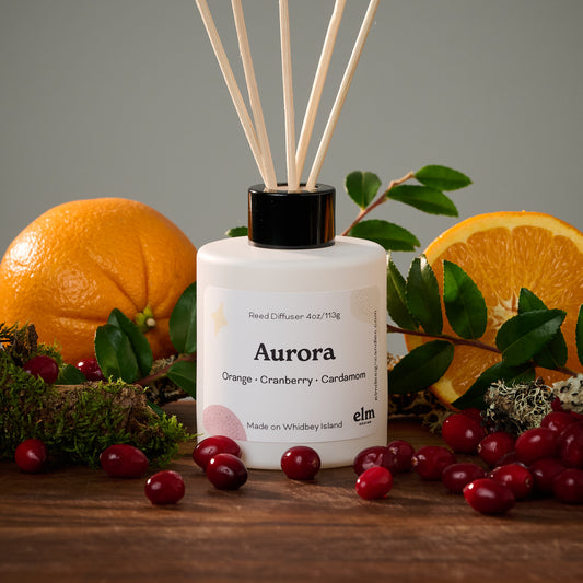 Elm Design's reed diffuser in scent "Aurora". 4oz bottle with reeds