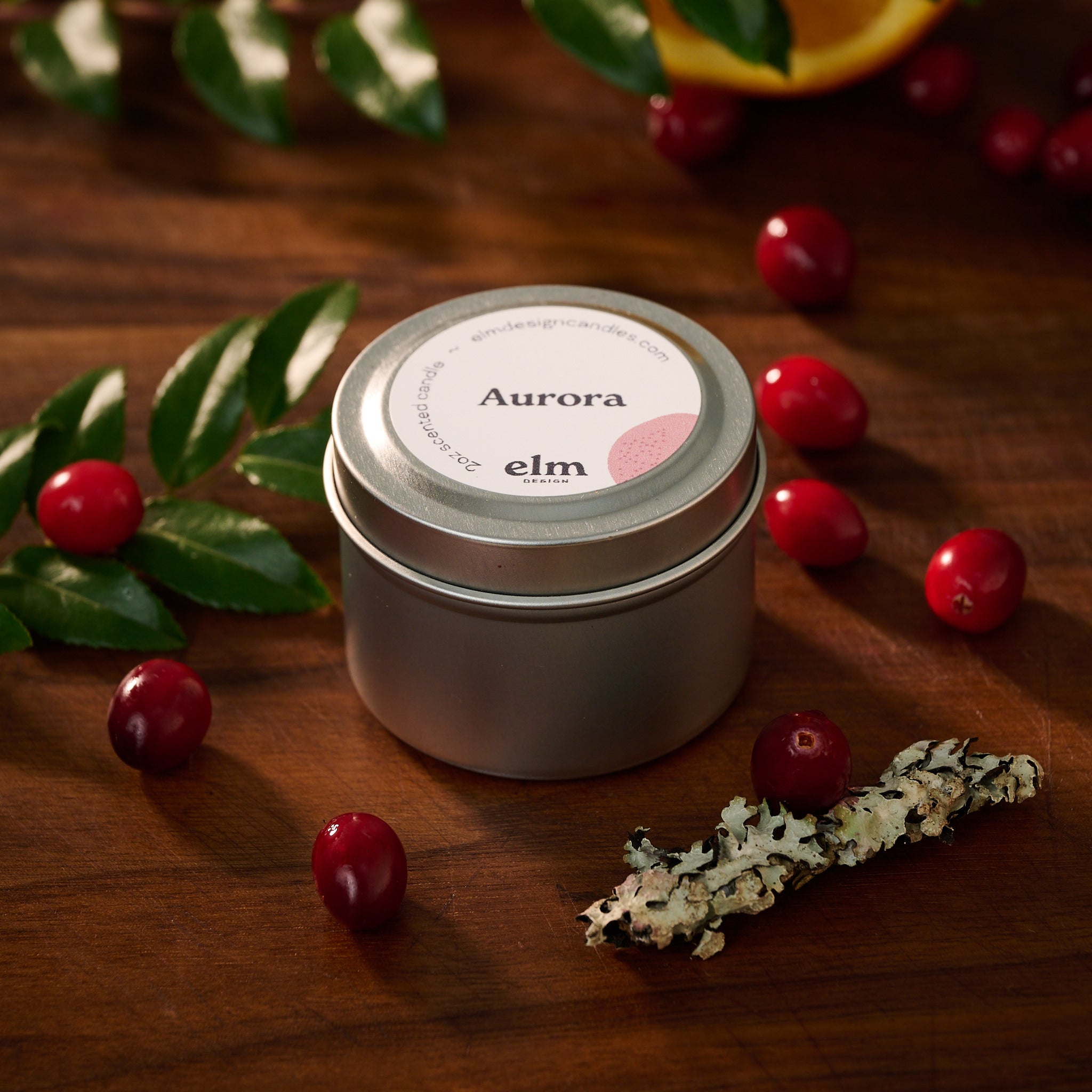 Elm Design's scented candle "Aurora" in a 2oz travel tin.