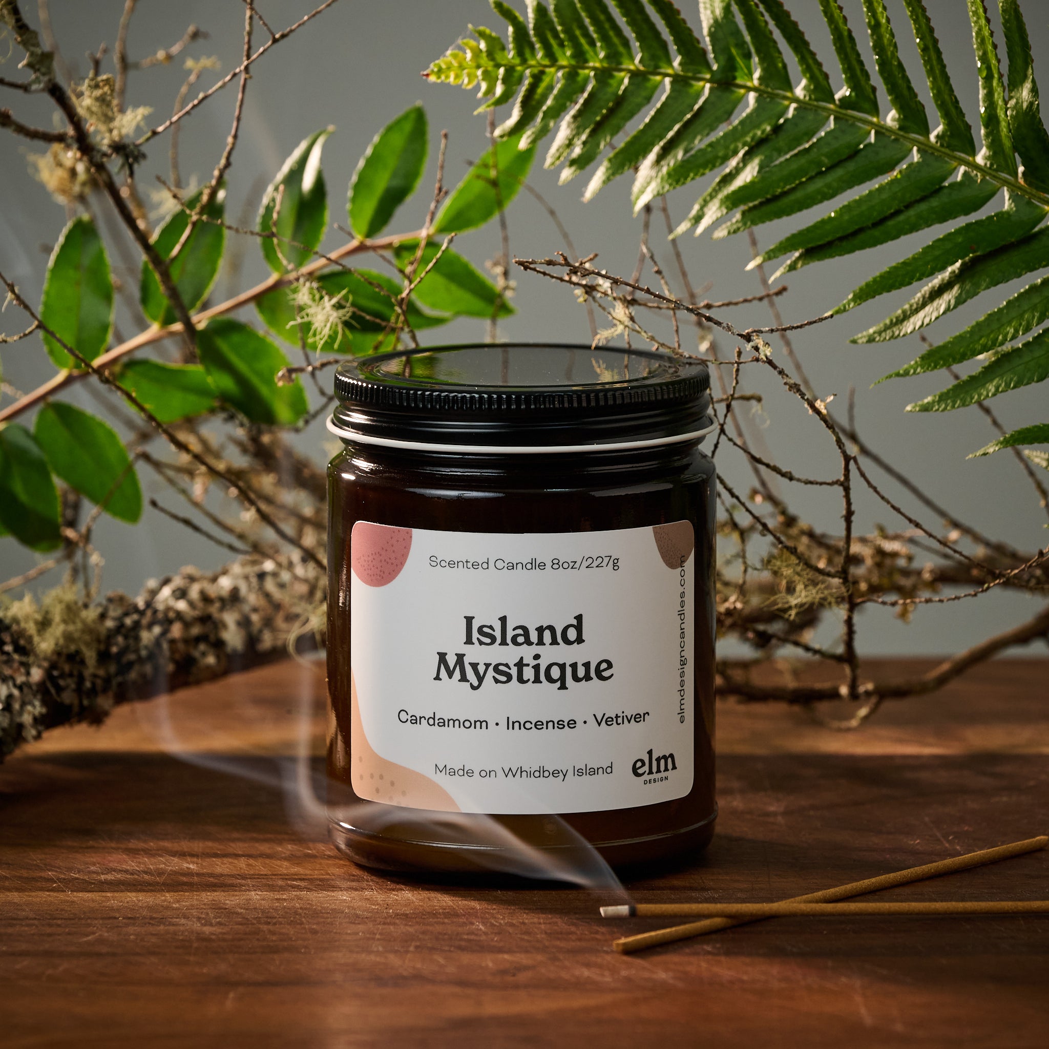 Elm Design's scented candle "Island Mystique" in an 8oz glass jar.