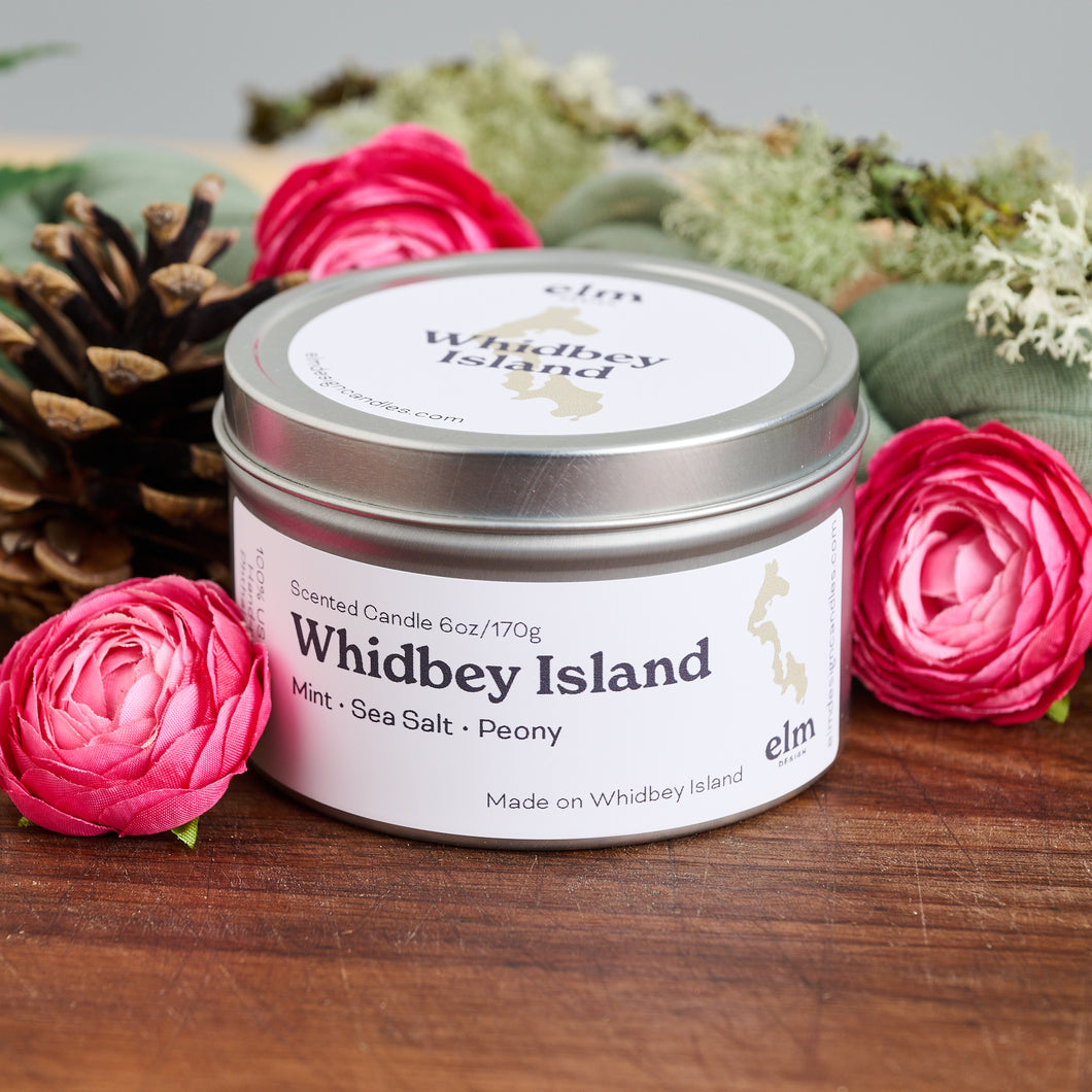 Elm Design Candles scented candle in Whidbey Island scent in 6oz metal tin.