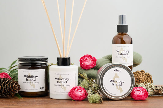 Elm Design's scent Whidbey Island in a group photo with an 8oz jar, 4oz reed diffuser, 6oz metal tin, and 4oz room spray.