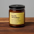 Load image into Gallery viewer, Sunlit Whidbey scented soy candle in amber glass jar on wooden surface.

