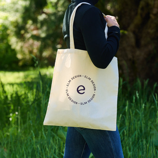 Canvas tote bag with Elm Design logo worn on shoulder