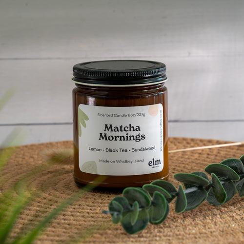Matcha Mornings scented soy candle in colorfully labeled 8 oz container.