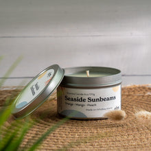 Load image into Gallery viewer, Seaside Sunbeams scented soy candle in colorfully labeled 6 oz container.

