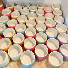 Load image into Gallery viewer, Our chakra vessels colored and ready for the kiln.

