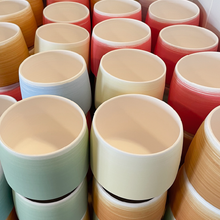 Load image into Gallery viewer, Briggs Shore red and orange ceramic vessels ready to be kiln fired.
