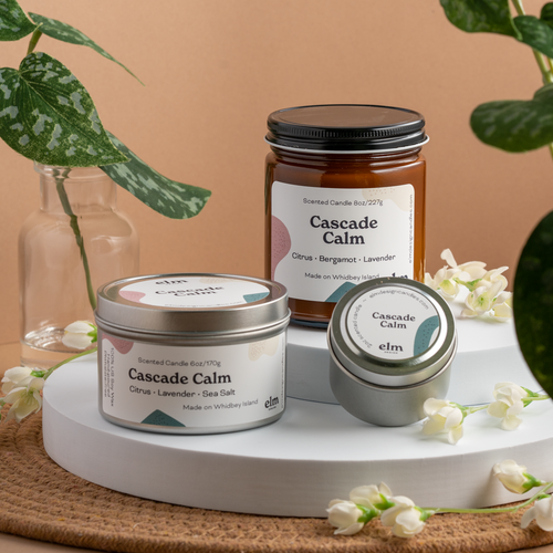 Cascade Calm scented soy candles in colorfully labeled 8, 6 and 2 oz containers.