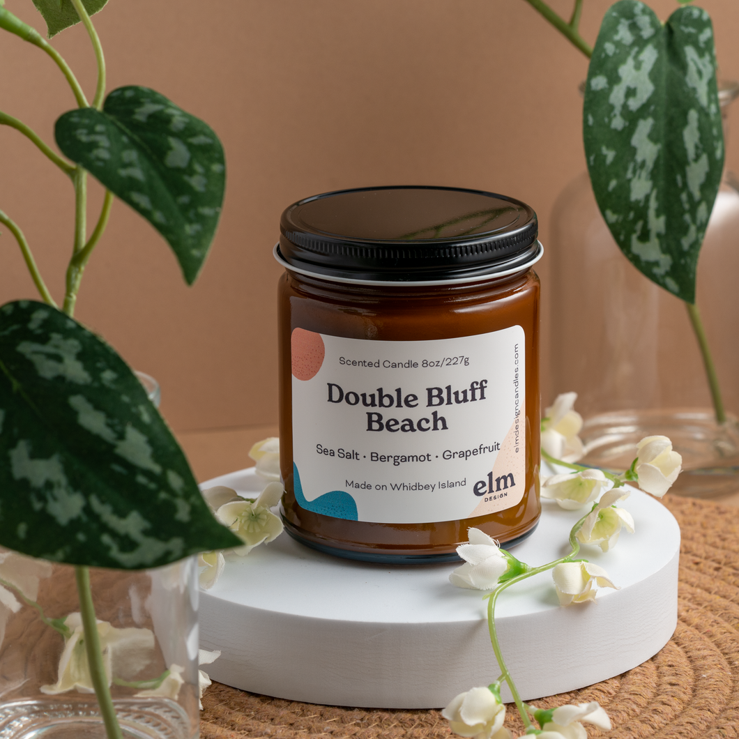 Double Bluff Beach scented soy candle in colorfully labeled 8 oz container.