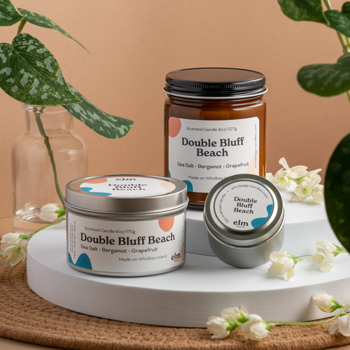 Double Bluff Beach scented soy candles in colorfully labeled 8, 6 and 2 oz containers.