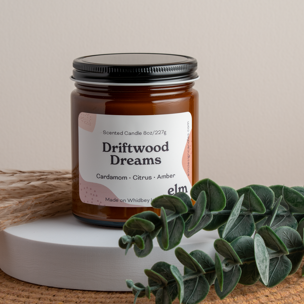 Driftwood Dreams scented soy candle in colorfully labeled 8 oz container.
