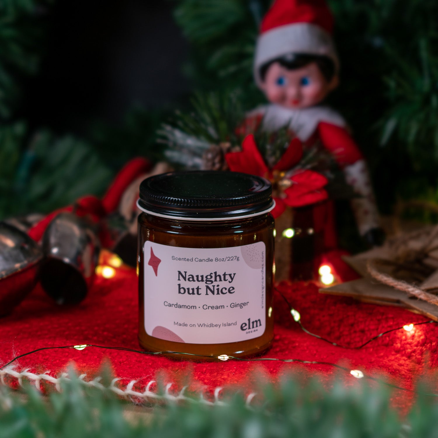 Naughty but Nice scented soy candle in colorfully labeled 8 oz container.