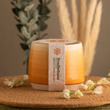 Load image into Gallery viewer, 20oz Sacral Chakra scented soy candle, in a hand crafted orange Briggs Shore ceramic vessel.
