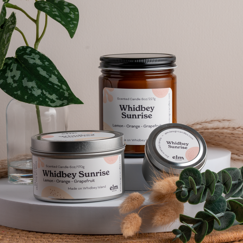 Whidbey Sunrise scented soy candles in colorfully labeled 8, 6 and 2 oz containers.