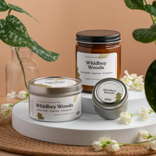 Load image into Gallery viewer, Whidbey Woods scented soy candles in colorfully labeled 8, 6 and 2 oz containers.
